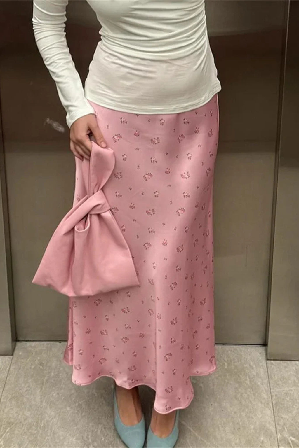 Side profile of bias-cut satin skirt demonstrating silhouette