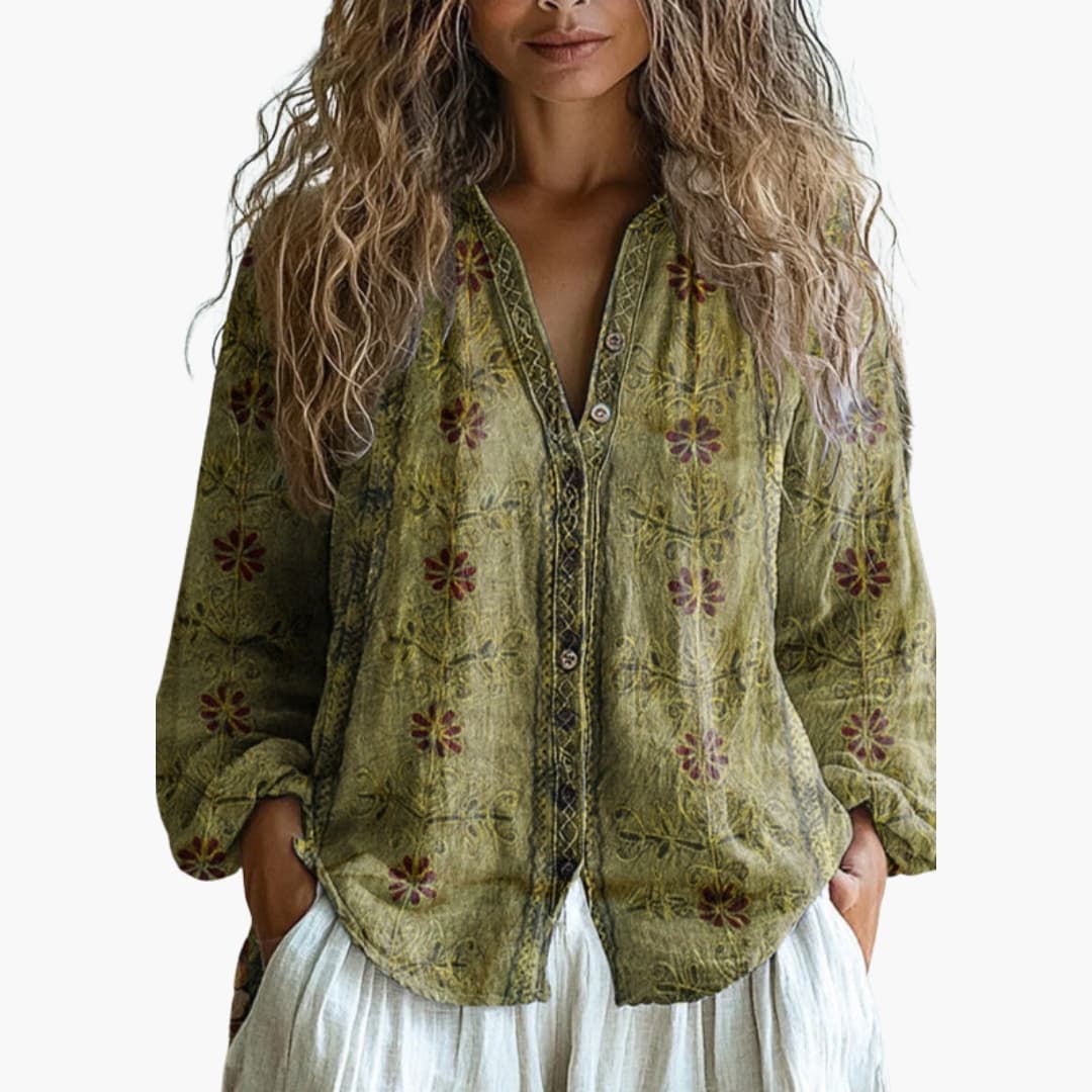Close-up of floral embroidery and green trim detailing on blouse front