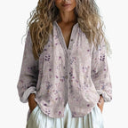 Woman wearing purple embroidered blouse, styled outfit detail