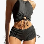 Model wearing ribbed halter bikini set, side angle showing ruched detailing