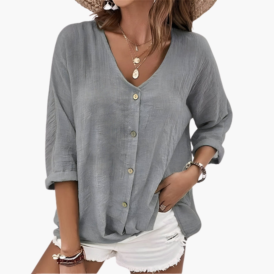 Model wearing sage green blouse, front view showing V-neck and button closure