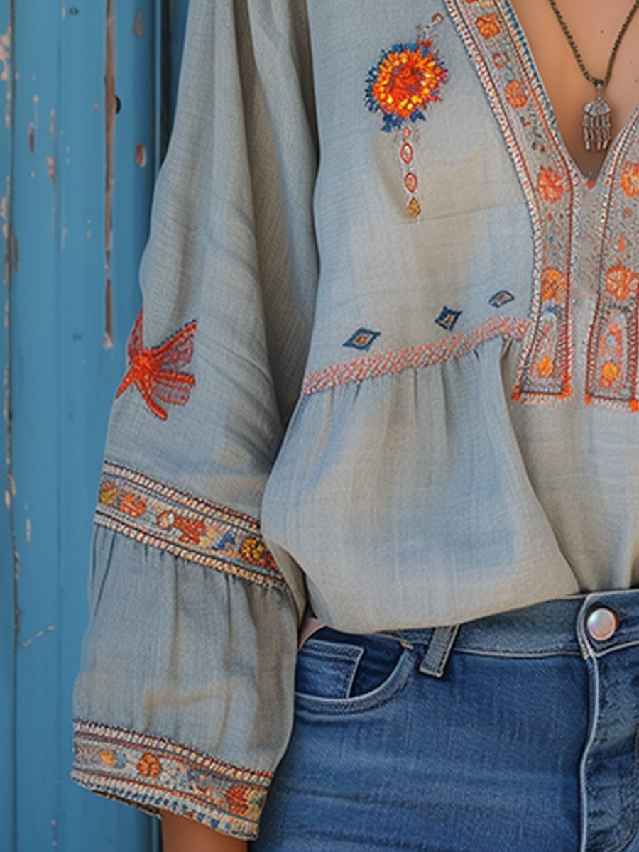 Side profile showing embroidered sleeves and relaxed fit silhouette