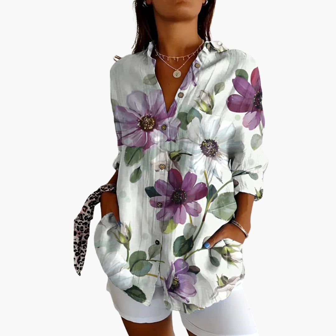 Model in relaxed seated pose wearing the embroidered shirt