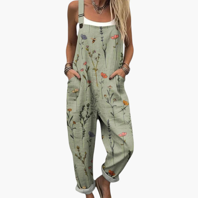 Woman wearing sage green floral dungaree jumpsuit with wide legs, frontal view