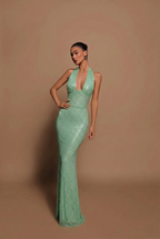 Model wearing sequin maxi dress in standing pose, full length