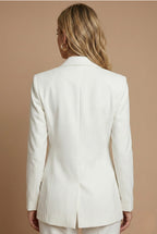 Model wearing tailored blazer set, standing pose from the side