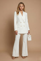 Women's double breasted blazer and flared trousers suit set on model, full front view