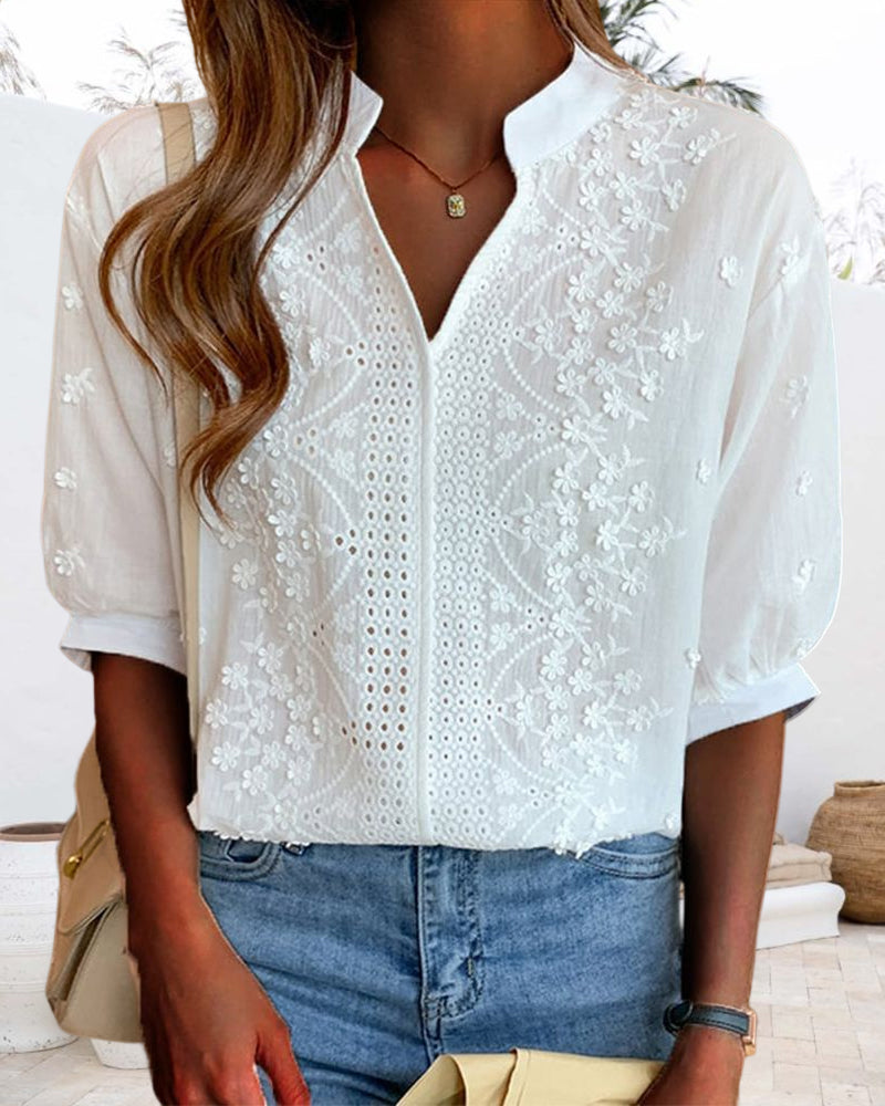 Close-up of floral embroidery and eyelet lace detailing on blouse front