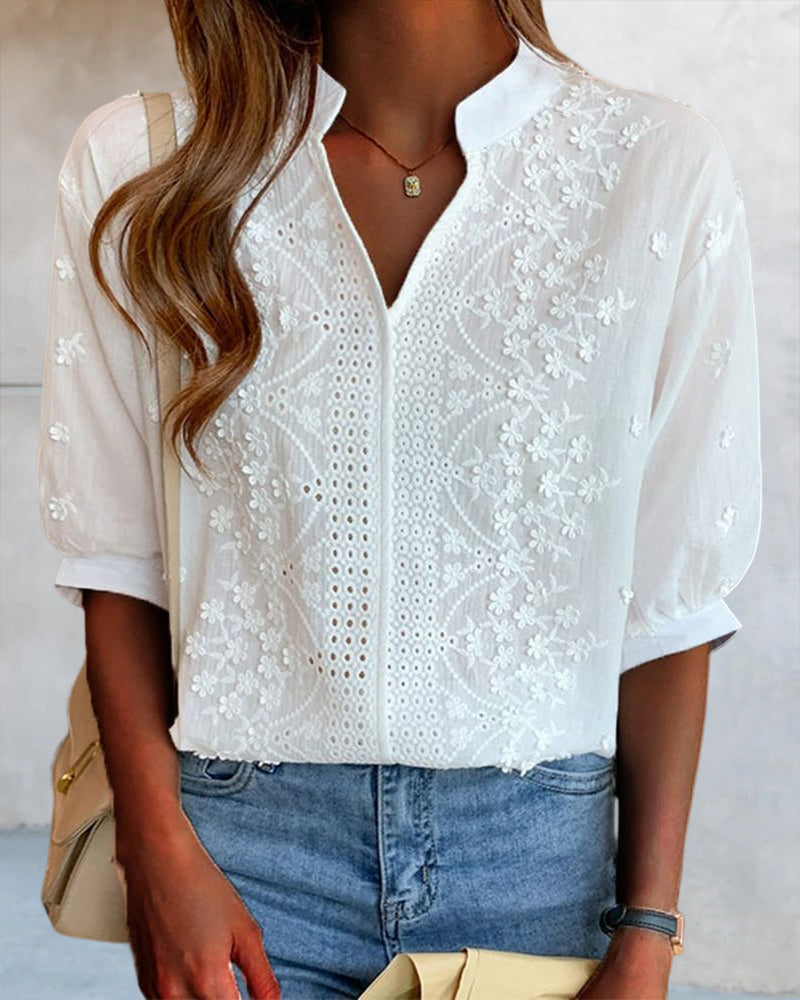 Back view of white V-neck blouse with embroidered panels
