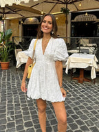 Model wearing white lace dress, full-length standing pose