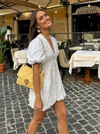 Puff sleeve detail on white lace mini dress