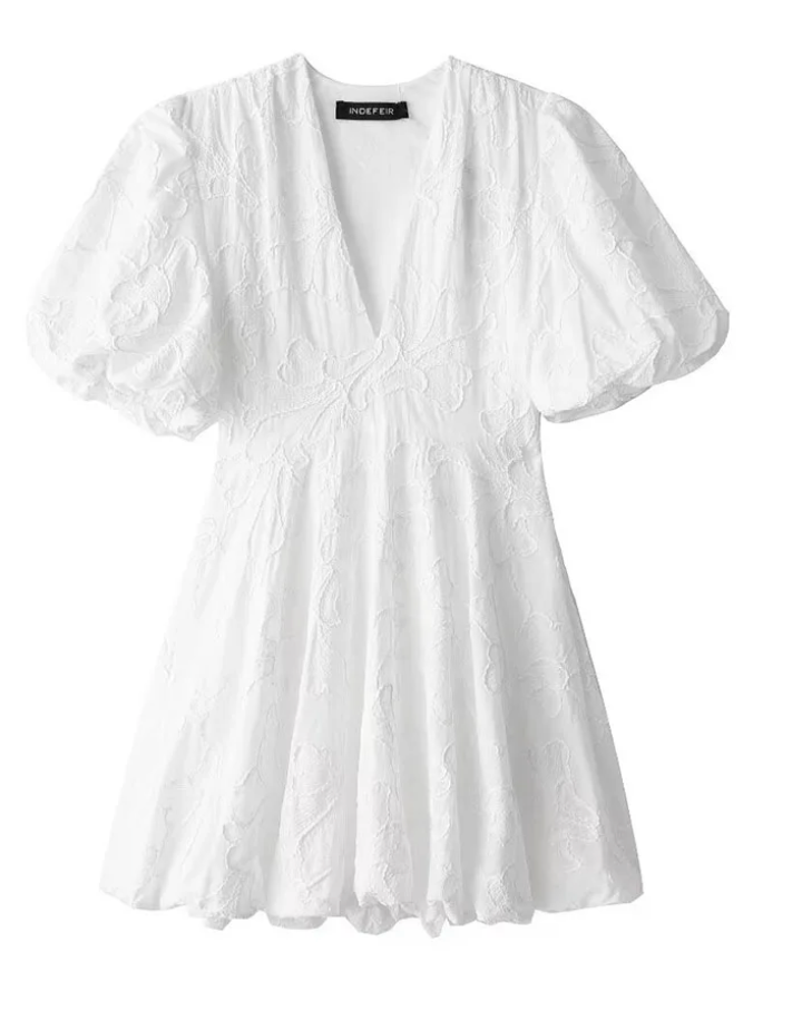 Model in white lace dress, side angle showing A-line skirt