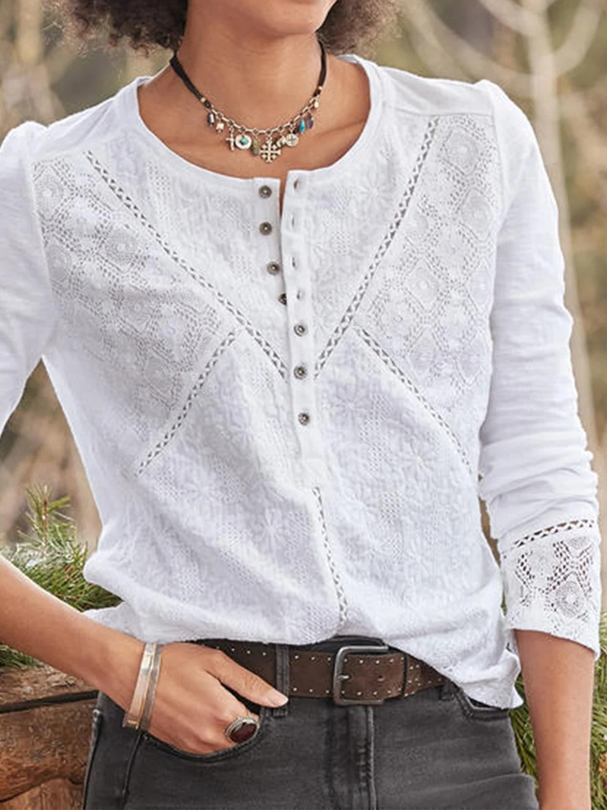White lace embroidered blouse with long sleeves and button front, displayed flat
