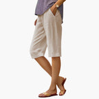 Model wearing relaxed linen shorts, standing pose