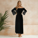 Model in lace maxi dress posing side profile, showing sleeve detail