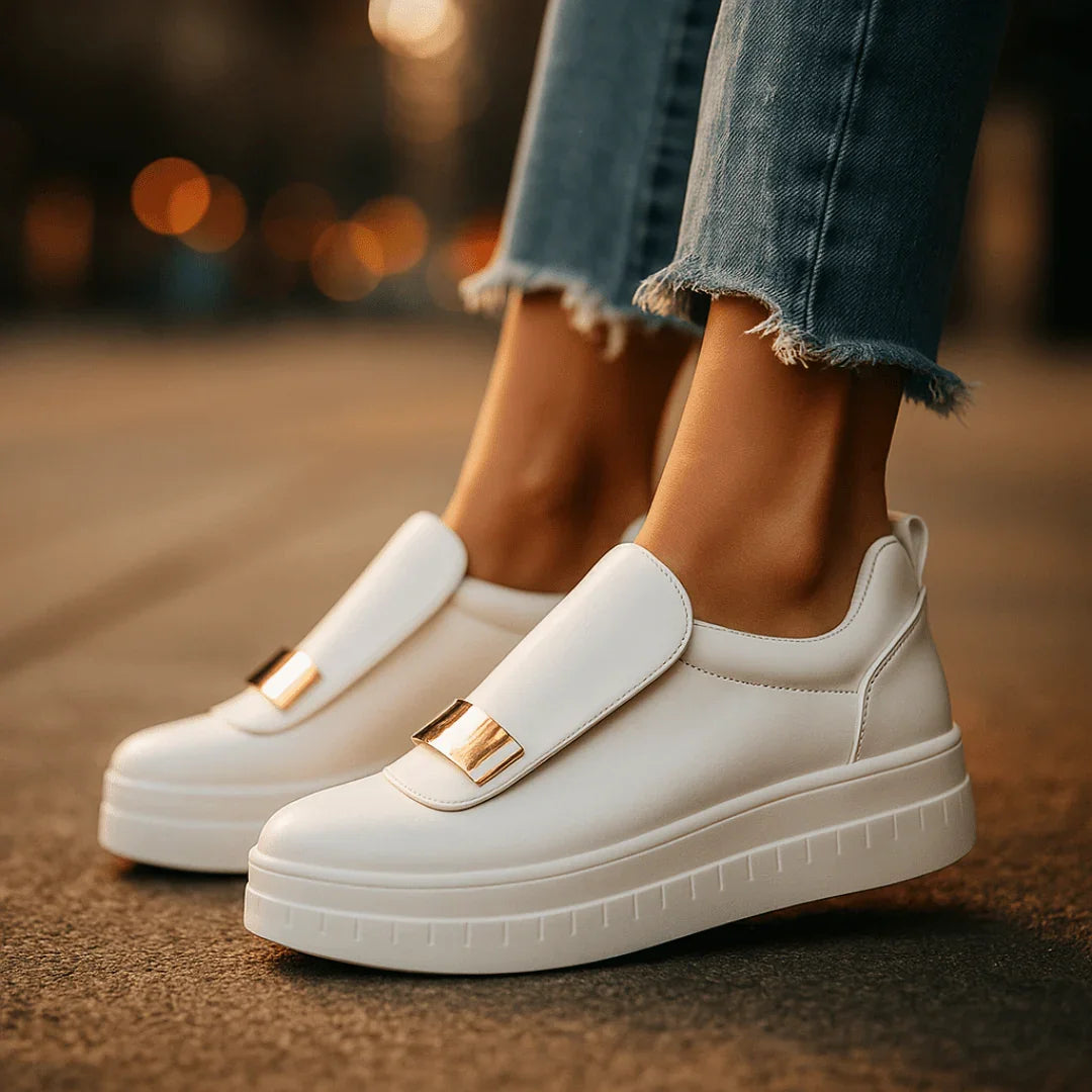 Women's black platform slip-on loafers with gold bar detail, front view
