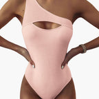 Model wearing one shoulder swimsuit, side pose showing cutout detail