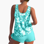 Model wearing floral tankini top and shorts, standing pose
