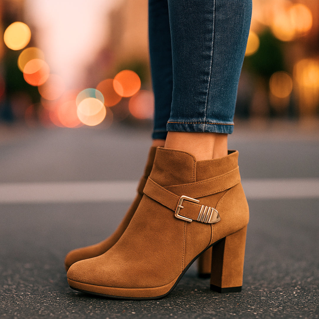 Model in office wear styling beige suede ankle boots
