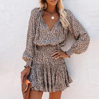 Woman wearing beige leopard print mini dress with long sleeves, front view