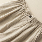 Walking pose in linen knee-length shorts from side angle