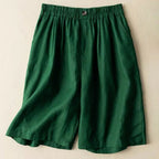 Close-up of pleated front detailing on linen shorts