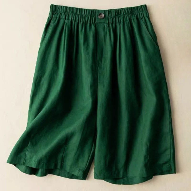 Close-up of pleated front detailing on linen shorts