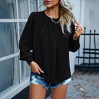 Model in beige pleated blouse, back and angled view
