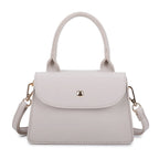 Women's structured mini handbag with flap closure and gold stud detail, front view