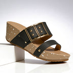 Close-up detail of oversized gold buckle on wedge sandal