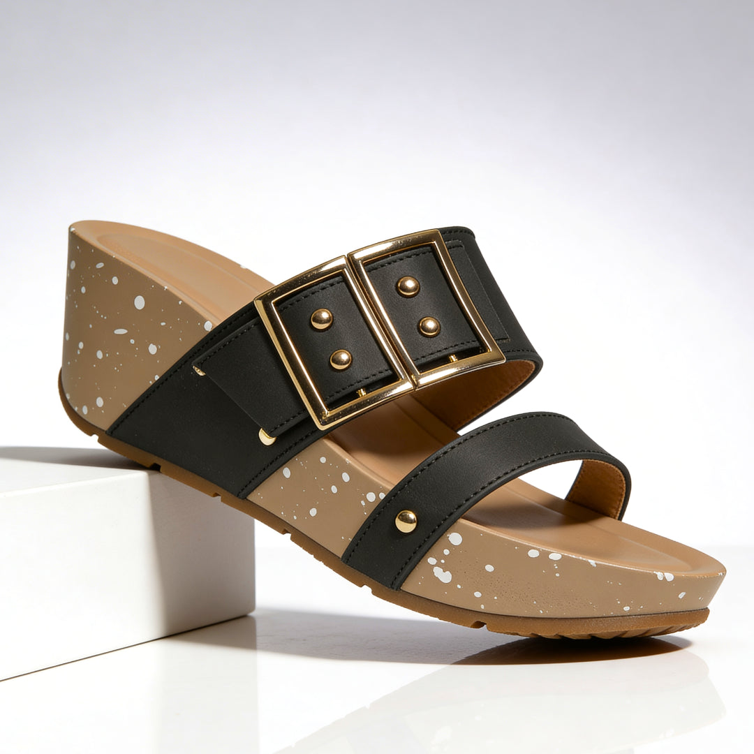 Close-up detail of oversized gold buckle on wedge sandal