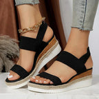 Model walking in beige stretch strap platform sandals, motion shot