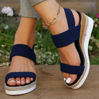Model seated wearing stretch strap platform sandals, lifestyle shot