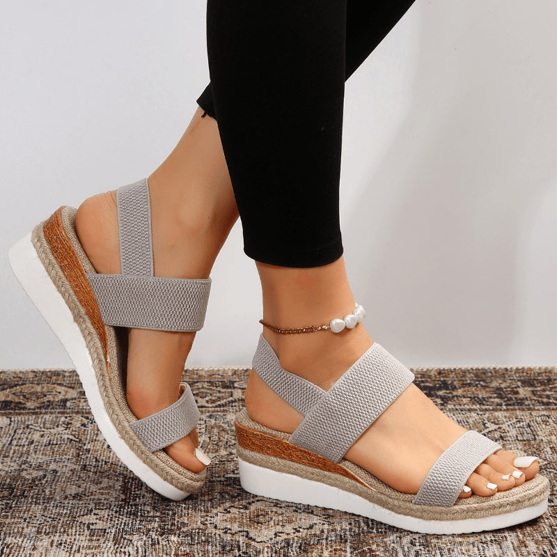 Model in relaxed outfit pairing platform espadrille sandals with casual wear