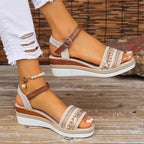 Beige espadrille wedge sandals with woven toe strap and tan ankle buckle, side view