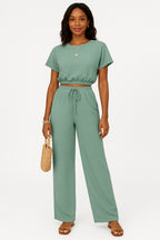 Model in co-ord set, relaxed standing position from the side