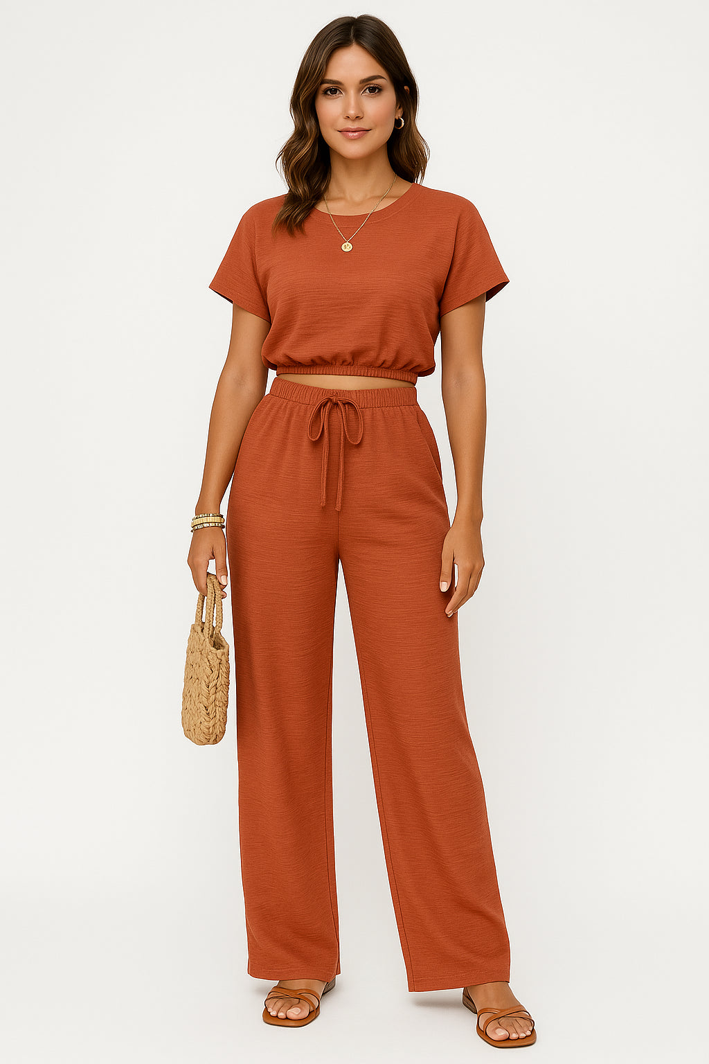 Model wearing crop top and wide leg trousers set, standing pose