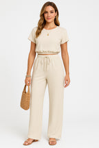 Women's crop top and wide leg trousers co-ord set in neutral tone, front view