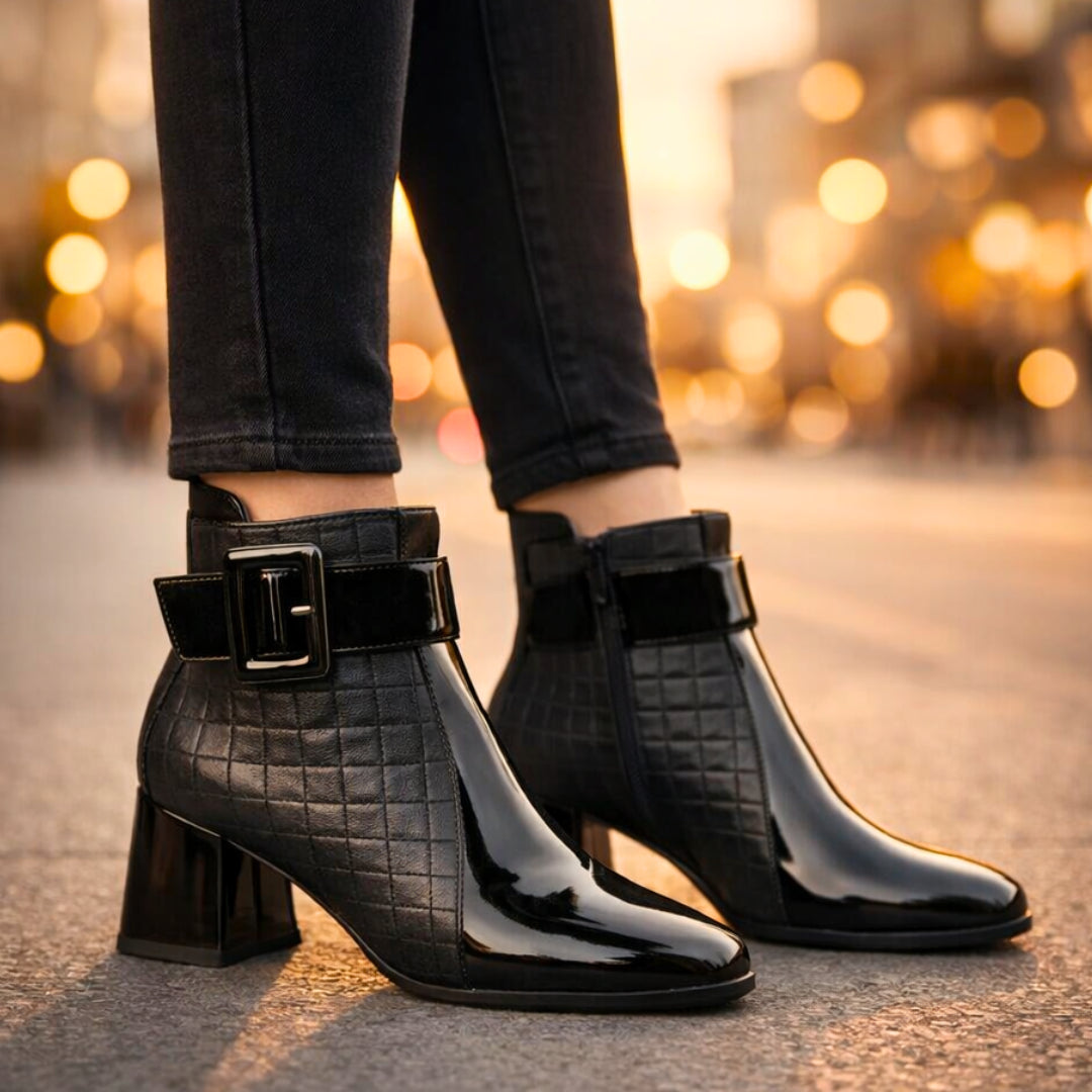 Front-facing view of quilted block heel ankle boots worn with styling