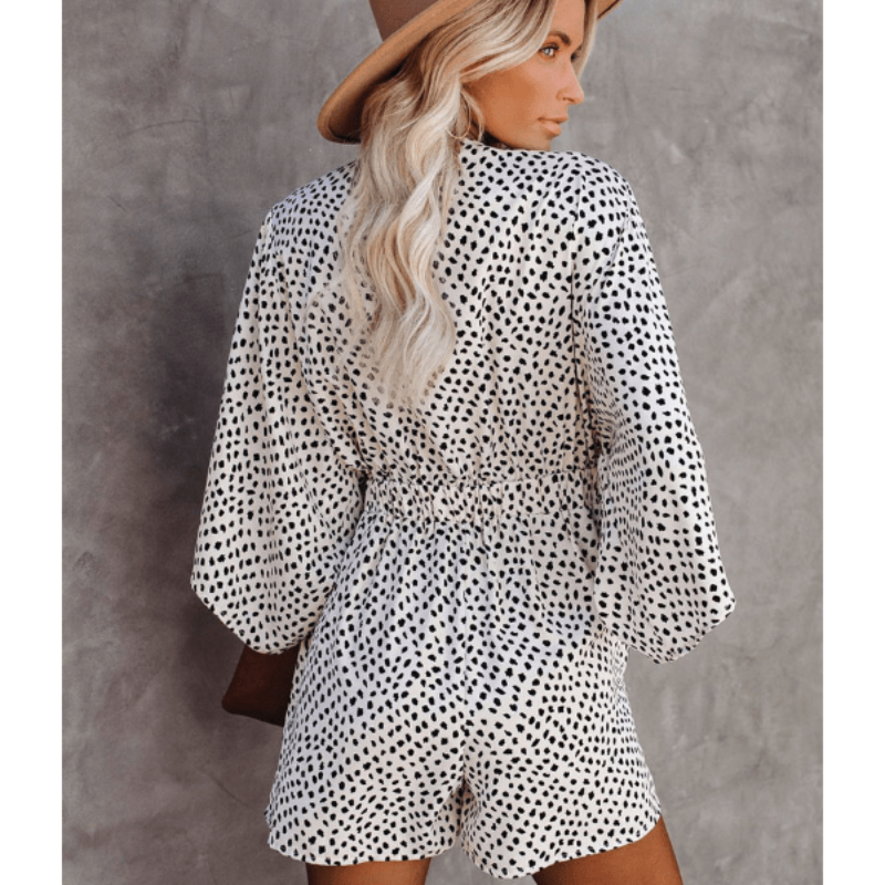 Woman posing in animal print romper showing full silhouette and movement