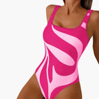 Model wearing graphic one piece swimsuit, side angle showing fit and strap detail