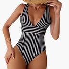 Black and white vertical striped one piece swimsuit with deep V neckline, front view