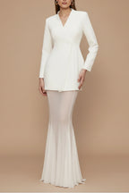 Model wearing blazer and skirt set, side profile pose