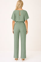 Jumpsuit laid flat on surface showing overall construction