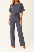 Model posing in jumpsuit, three-quarter angle