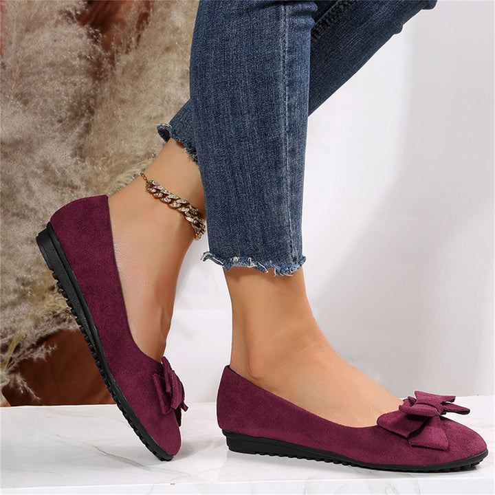 Black ballet flats styled with tailored trousers