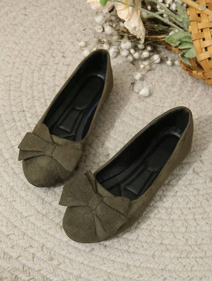 Close-up of bow detail on ballet flat