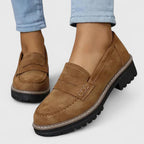 Side profile of black loafer highlighting chunky sole design