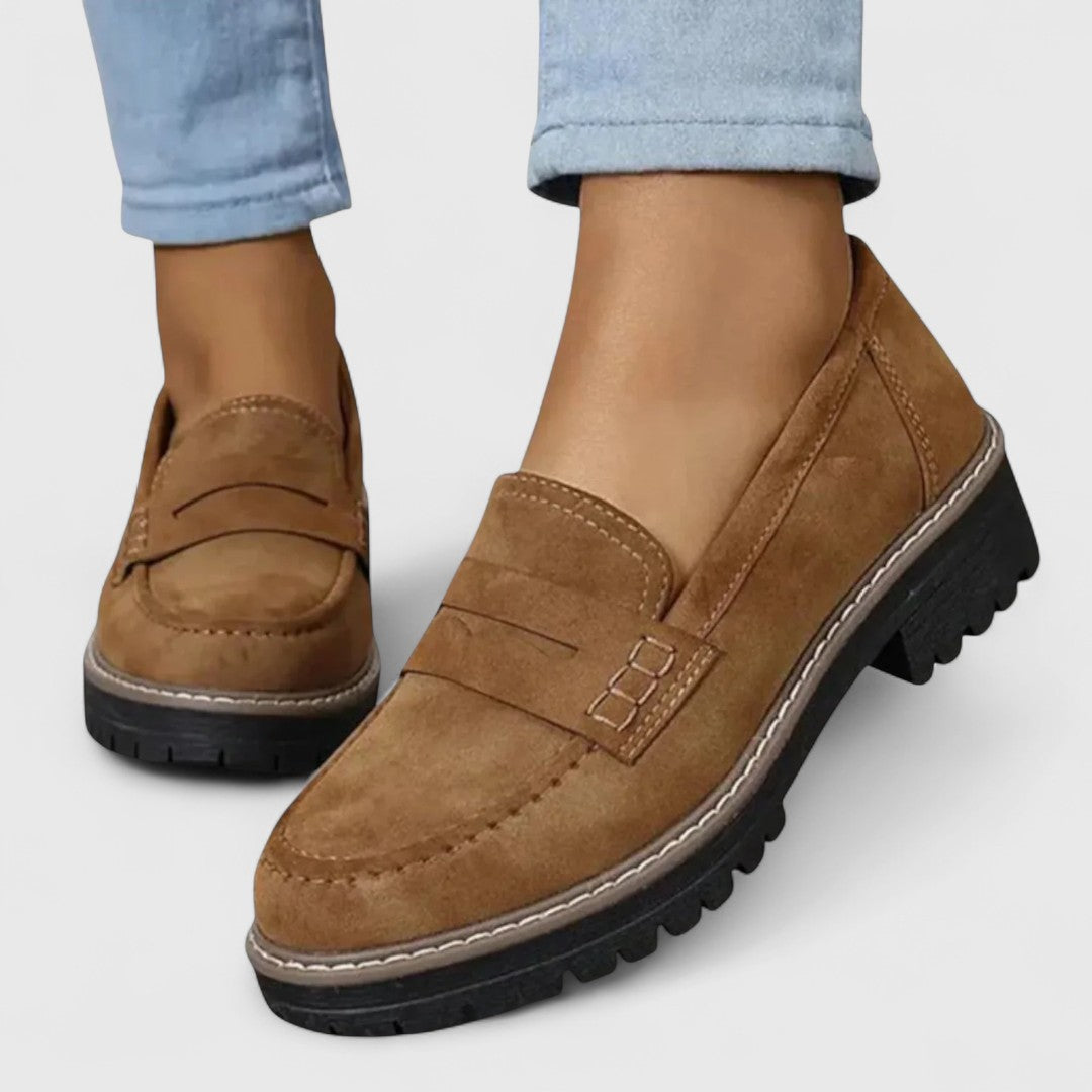 Side profile of black loafer highlighting chunky sole design