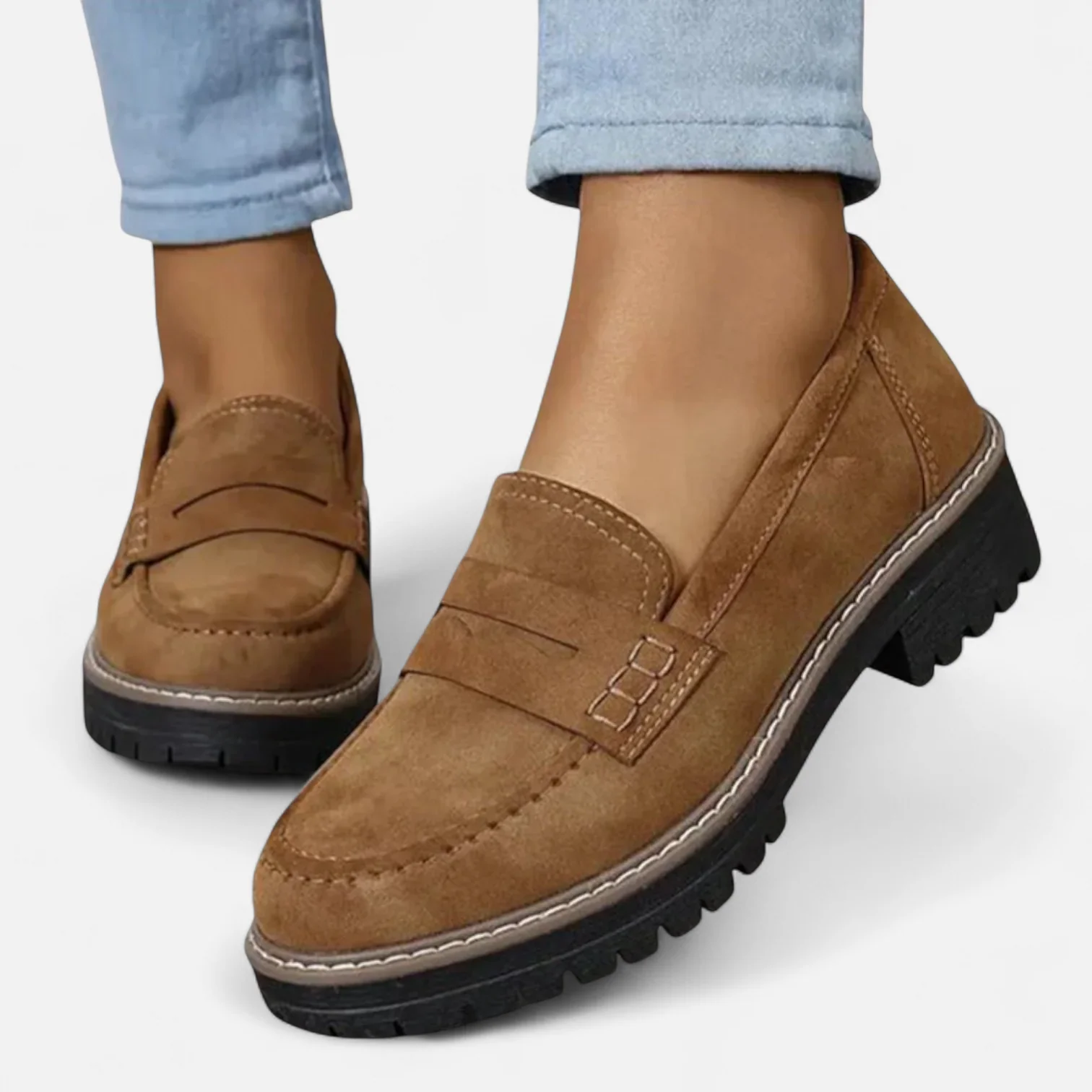 Woman wearing loafers seated, showing shoe detail